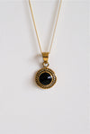 Colgante de bronce y obsidiana